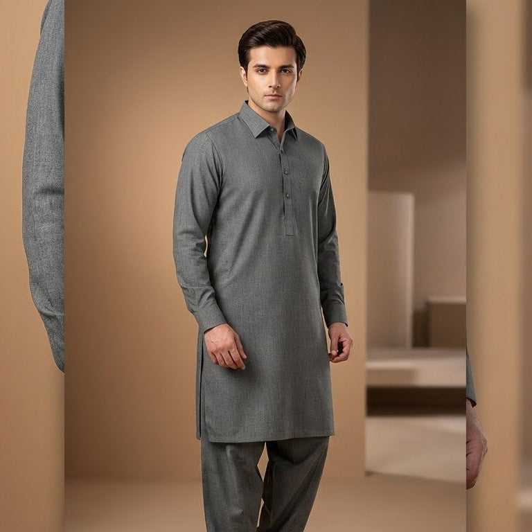 Man wearing a gray kurta standing in a neutral-colored room.